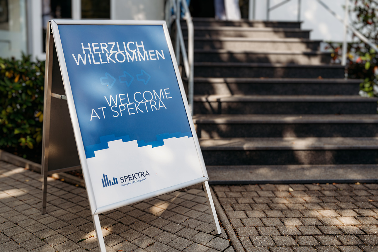 Welcome sign in front of the stairs to the main building of SPEKTRA GmbH in Dresden on the occasion of its 30th anniversary.